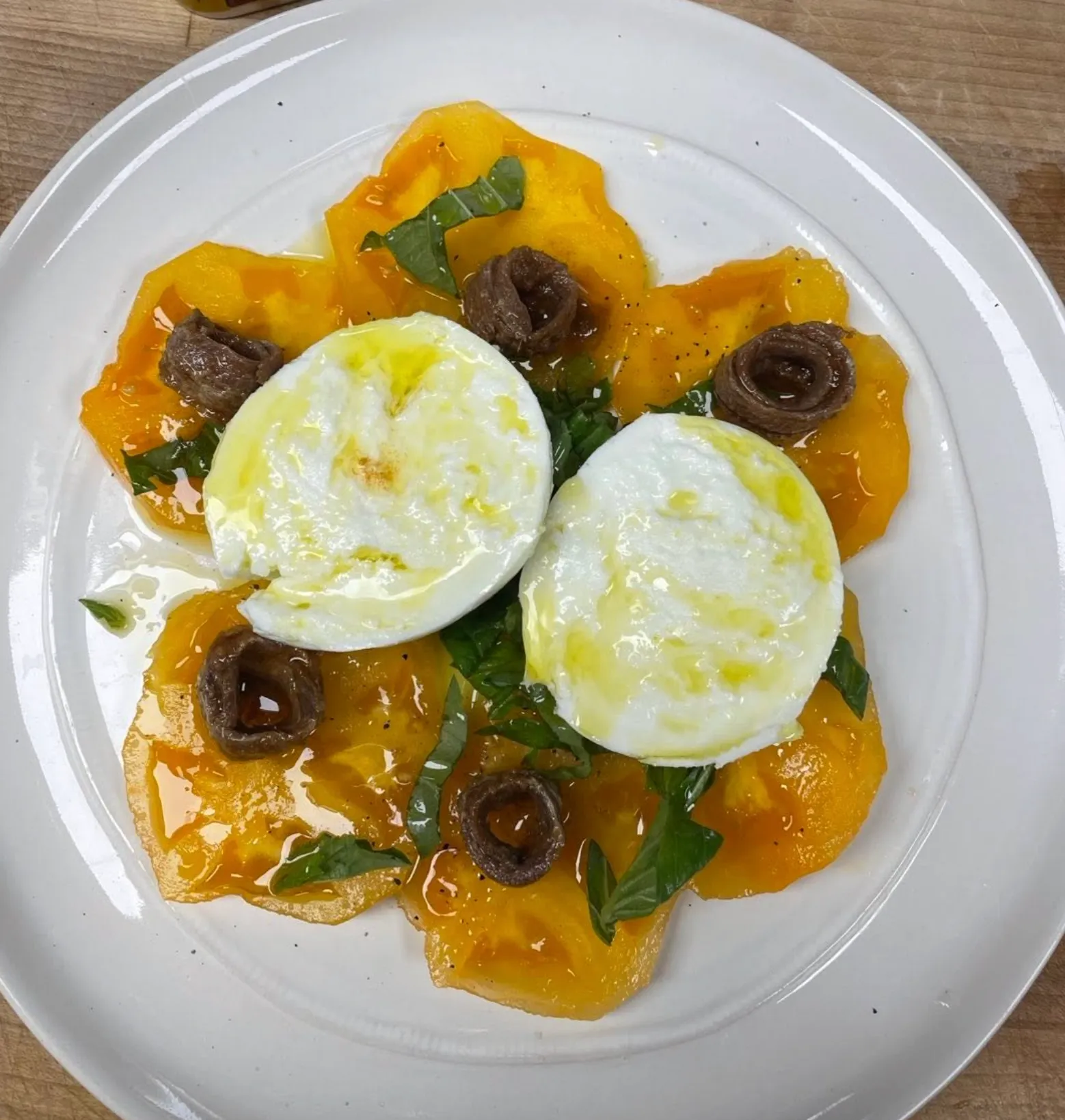 Burrata with anchovies and heirloom tomatoes