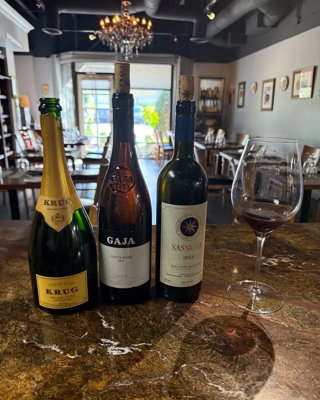 Krug, Gaja, and Sassicaia bottles at Onotria